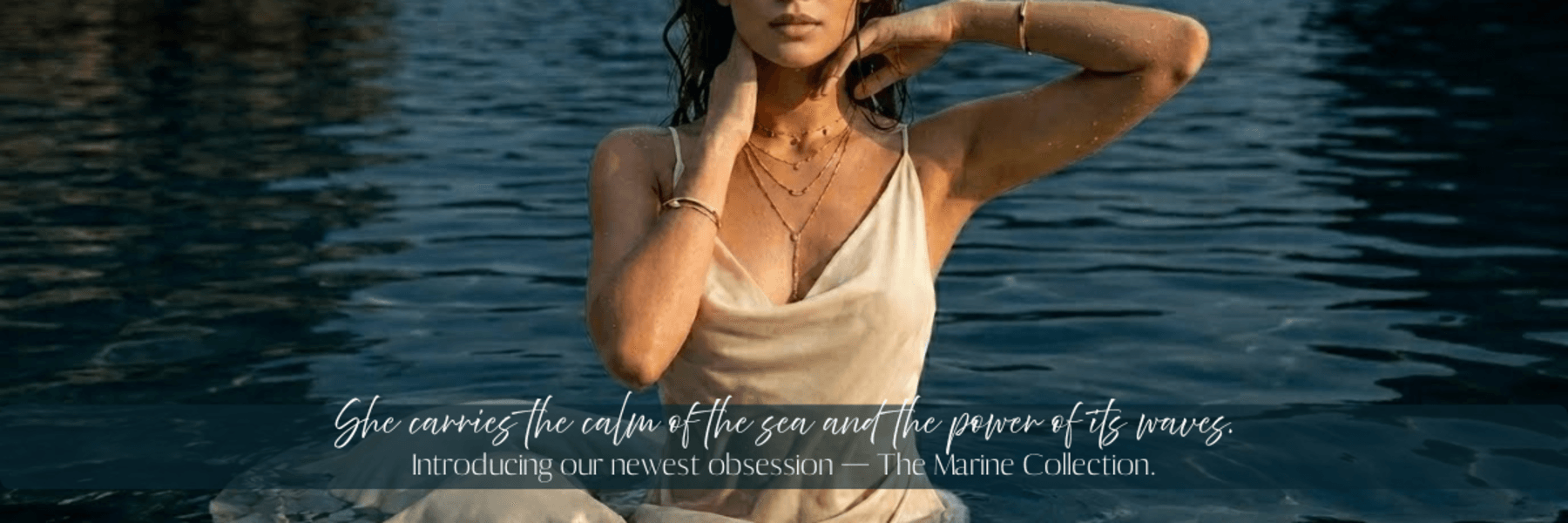 Model wearing layered gold jewellery